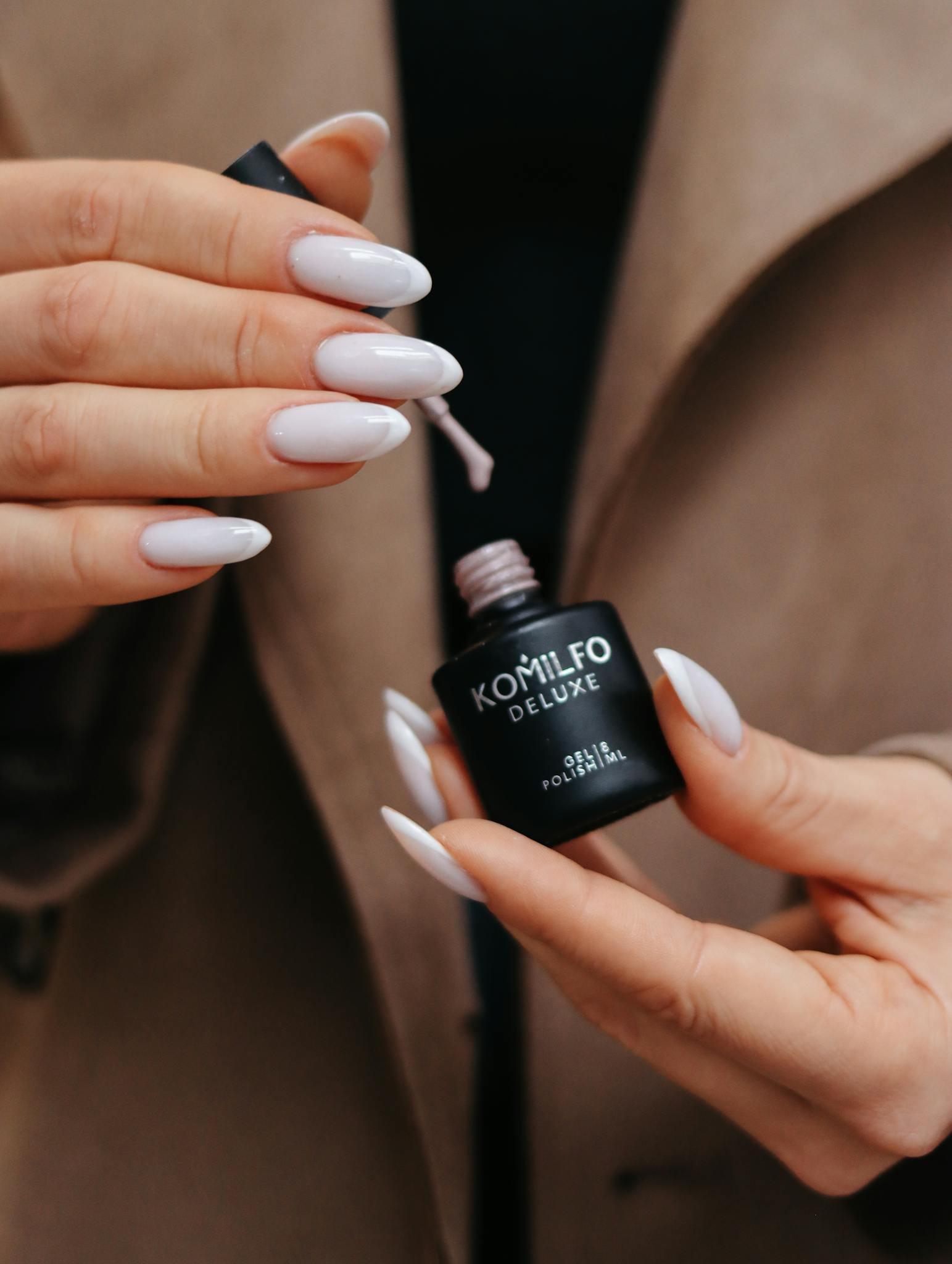 A close-up of gel nail polish application on well-manicured nails, showcasing elegance and modern style.